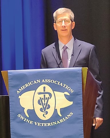 Dr. Mike Senn standing behind AASV podium