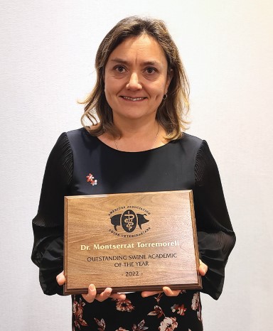Dr. Montserrat Torremorell holding plaque