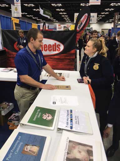 A FFA student at the AASV booth with Dr. Schmitt